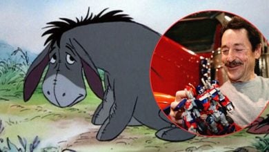 Eeyore from Winnie the Pooh appears with his signature forlorn expression, next to a cheerful guest showcasing a toy robot, all highlighted within a vibrant red circle—capturing a magical moment at the Disney theme park.