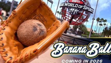 At ESPN Wide World of Sports Complex, a playful Savannah Bananas moment features a baseball glove holding a coconut, with bright “Banana Ball” signage in the background—showcasing the team’s signature zany championship fun for fans.