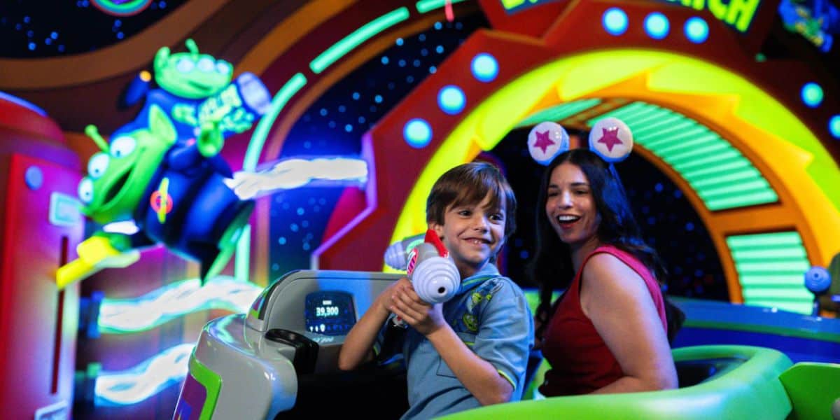 guests ride buzz lightyear space ranger spin in disney world's magic kingdom in tomorrowland area