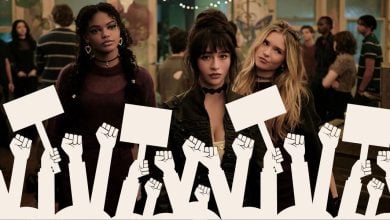 Three young women at a lively Disney-themed party stand behind a stylized animated crowd, holding up protest signs and raising their fists in solidarity with a religious group’s boycott of a controversial Disney+ series.
