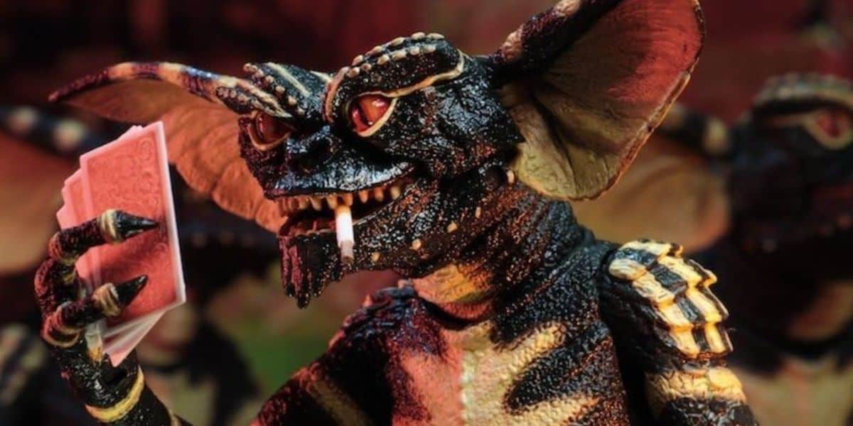 A mischievous gremlin playing cards in 'Gremlins' (1984)