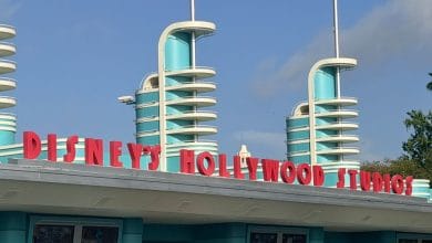 Disney’s Hollywood Studios Art Deco entrance pops with its iconic red sign and turquoise towers under a vibrant blue sky, radiating the buzz and anticipation of Cast Member Previews on September 14.