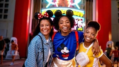 three guests in front of mickey and minnie's runaway railway ride in disney world's hollywood studios park