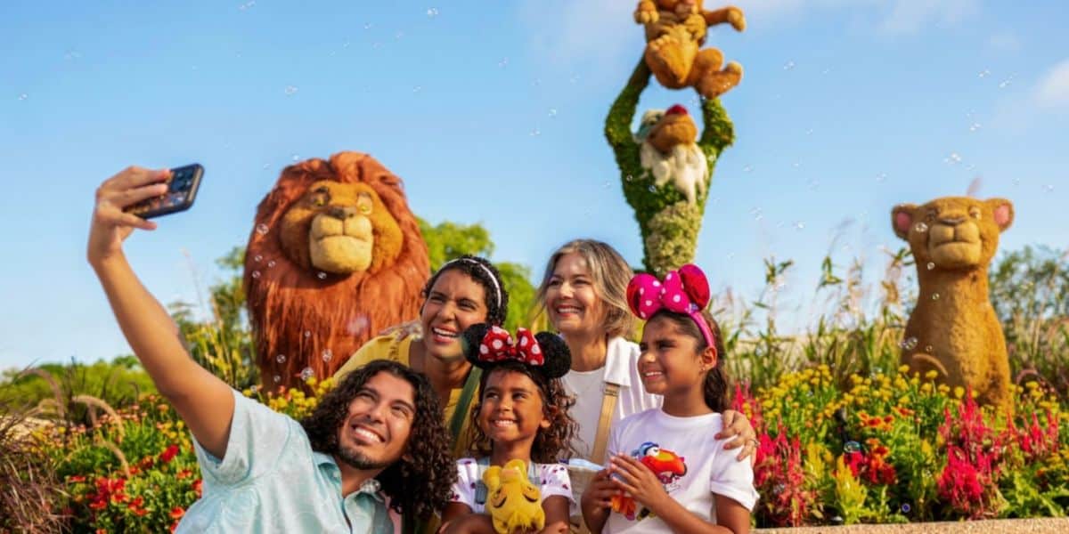 EPCOT guests take selfie in front of lion king topiaries during flower and garden festival