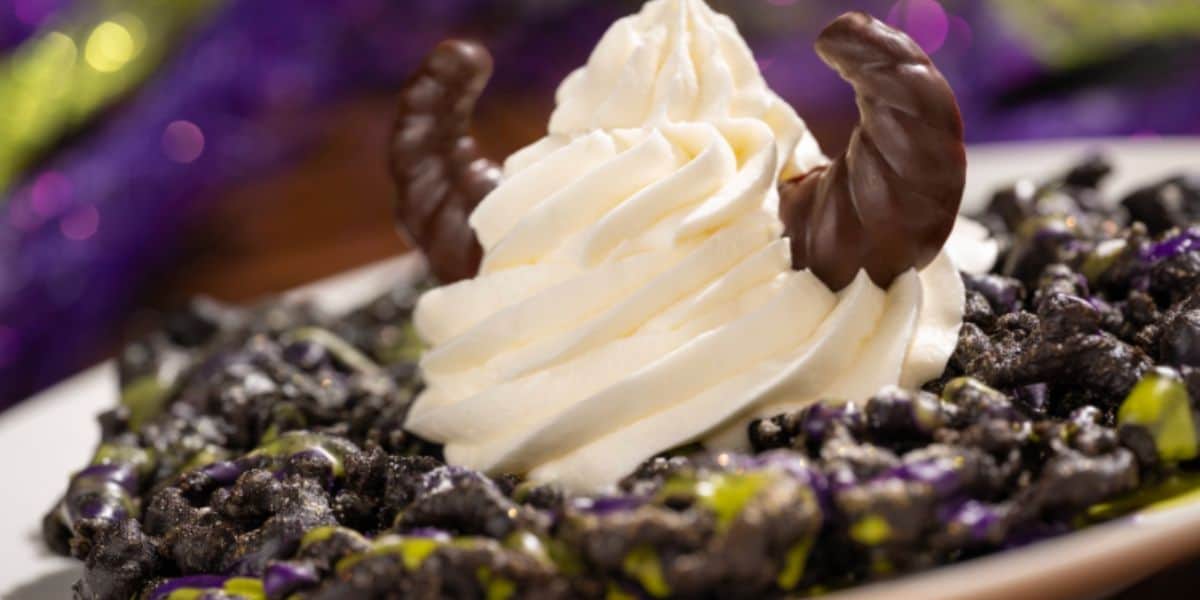 Maleficent Funnel Cake: Chocolate funnel cake topped with shimmer, powdered sugar, ube and matcha icings, vanilla soft-serve, and chocolate horns at Disney World for Halloween