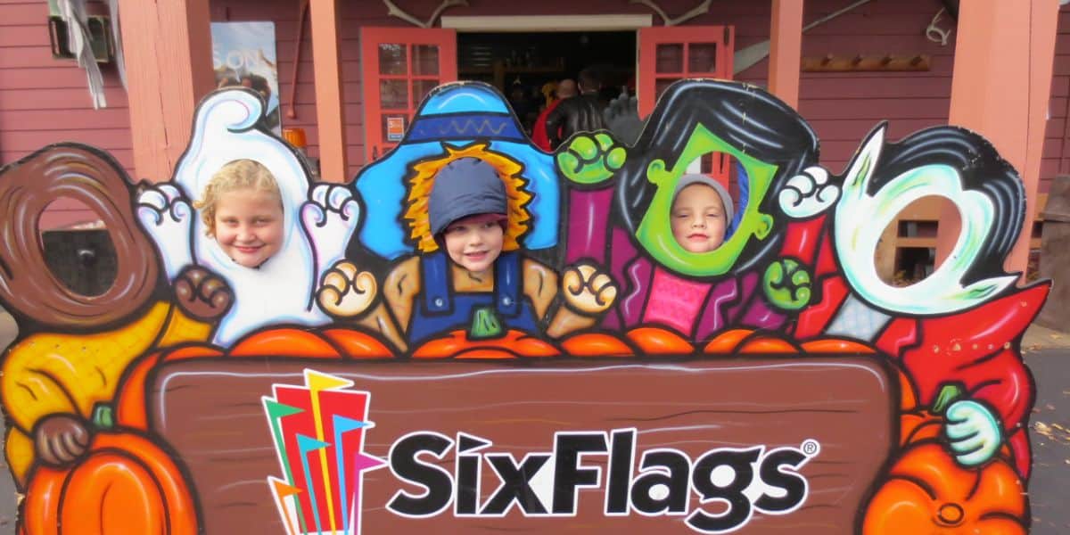 Kids in a Six Flags Halloween themed photo-op