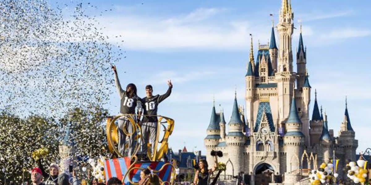 fans surround parade floats as UCF team rolls by Cinderella Castle in Disney World