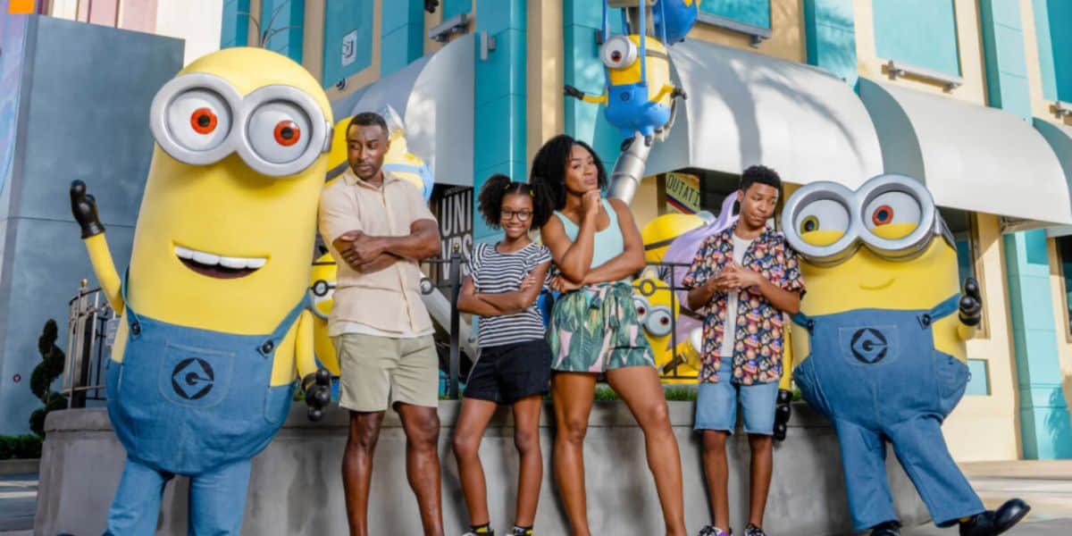 universal orlando guests pose with minions in minions land area inside of universal studios florida