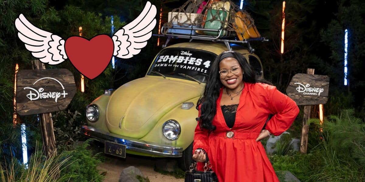 Carla Jeffery, dressed in a vibrant red outfit, beams in front of a vintage car stacked with luggage. Behind her, Disney+ and Disney Channel signs set the scene alongside a playful heart graphic—a delightful tribute to the beloved Disney Channel star that fans will instantly recognize.