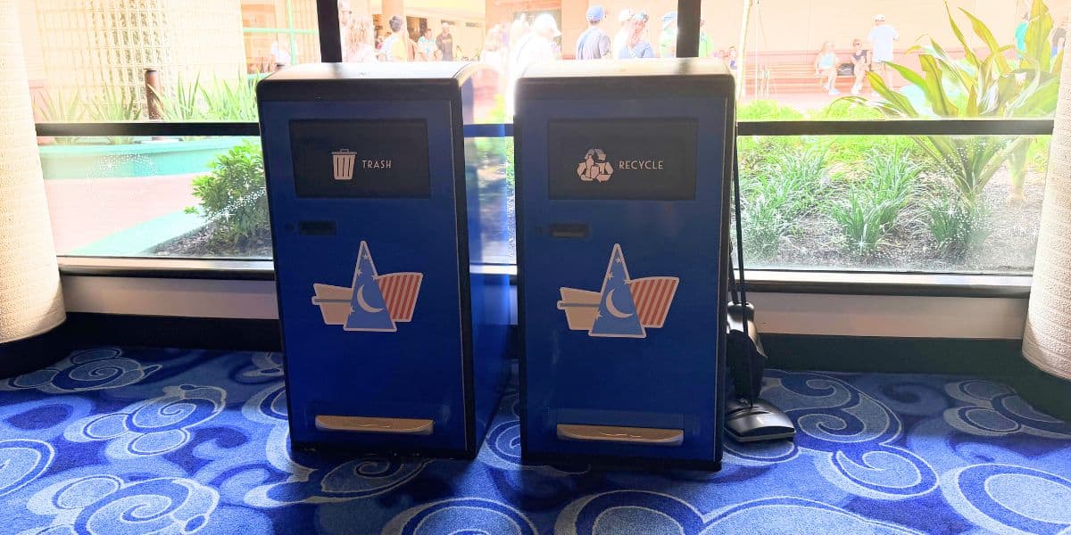 Blue trash and recycle bins featuring Sorcerer Mickey hat icons at Disney’s Contemporary Resort.