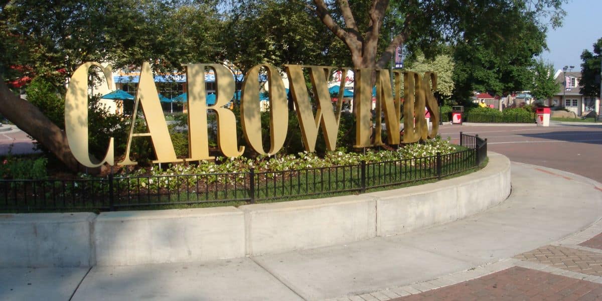 Large gold Carowinds logo at the park entrance.
