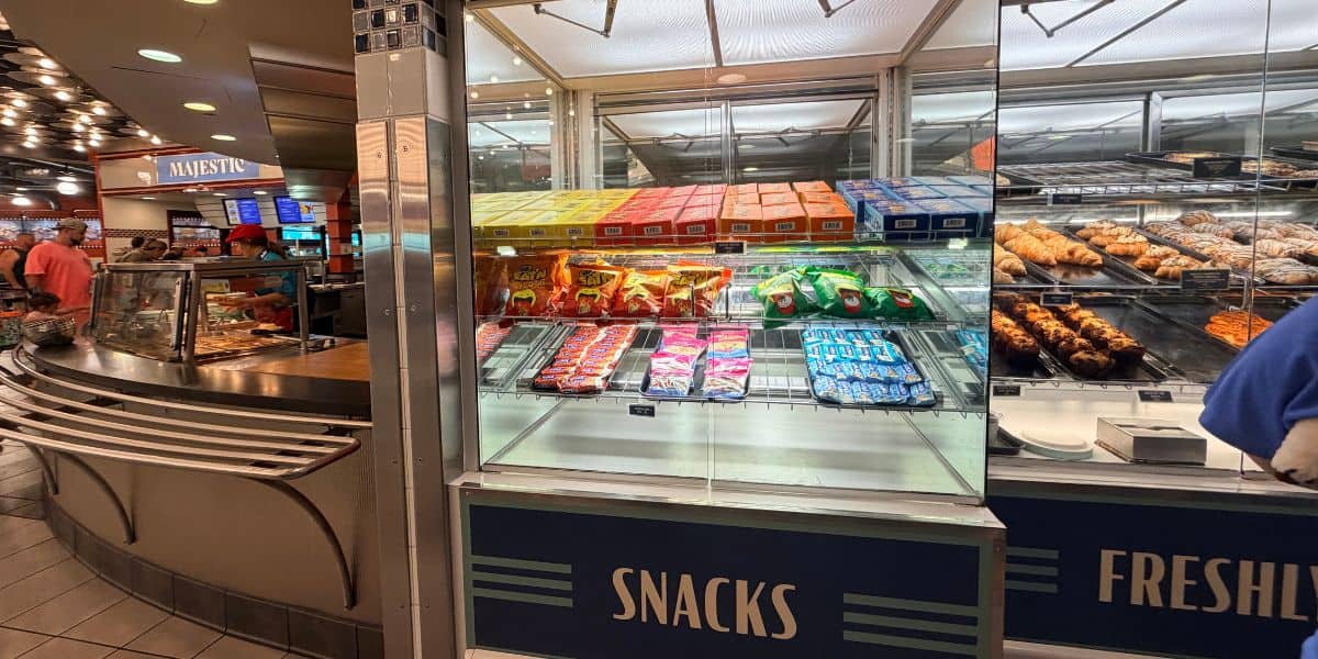 Display case of allergy-friendly snacks, chips, and pastries at an EPCOT food counter at Disney World.