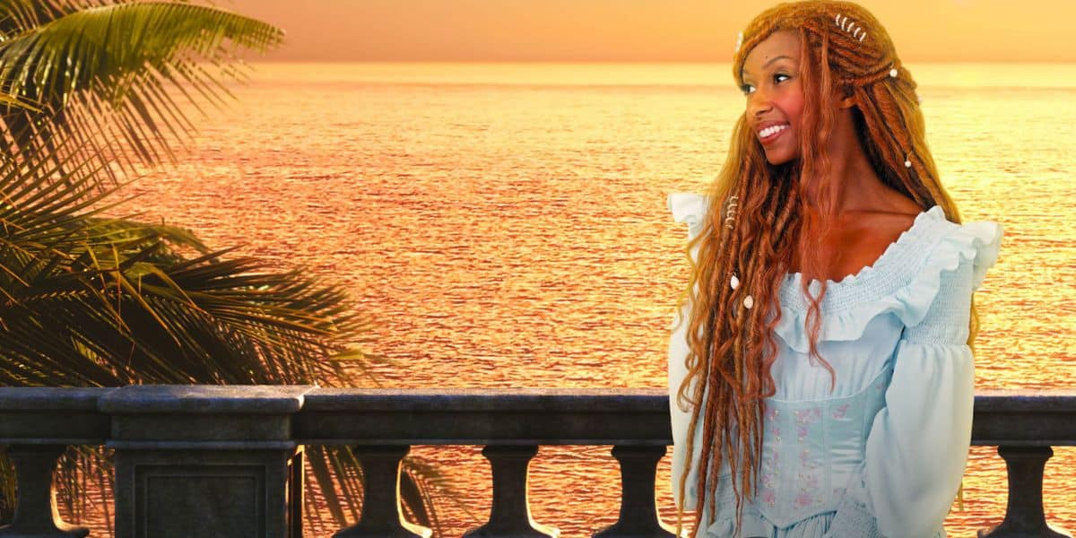 Ariel on her balcony overlooking the ocean at sunset.