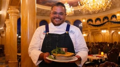 Chef Jerry holding a savory pie inside Be Our Guest at Magic Kingdom.