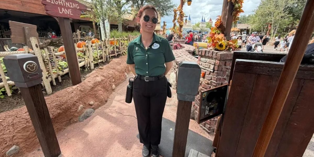 Disney cast member at the Big Thunder Mountain Railroad Lightning Lane entrance in Magic Kingdom.