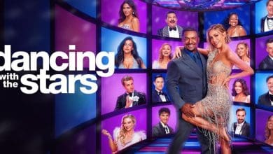 Dancing with the Stars hosts Alfonso Ribeiro and Julianne Hough in front of the season’s contestant cast wall.