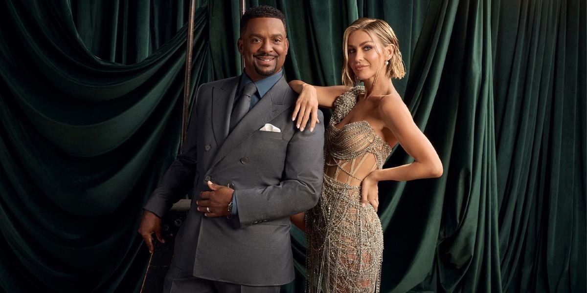 Alfonso Ribeiro and Julianne Hough pose in front of a green curtain for a Dancing with the Stars Disney+ promotion.