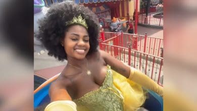 A guest riding Dumbo in an outfit that she was told violated the Disney dress code.