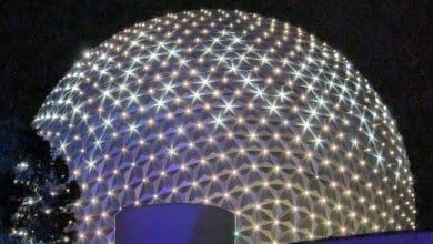 Spaceship Earth at Epcot glowing at night.