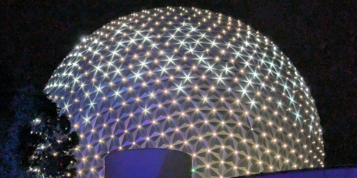 Spaceship Earth at Epcot glowing at night.