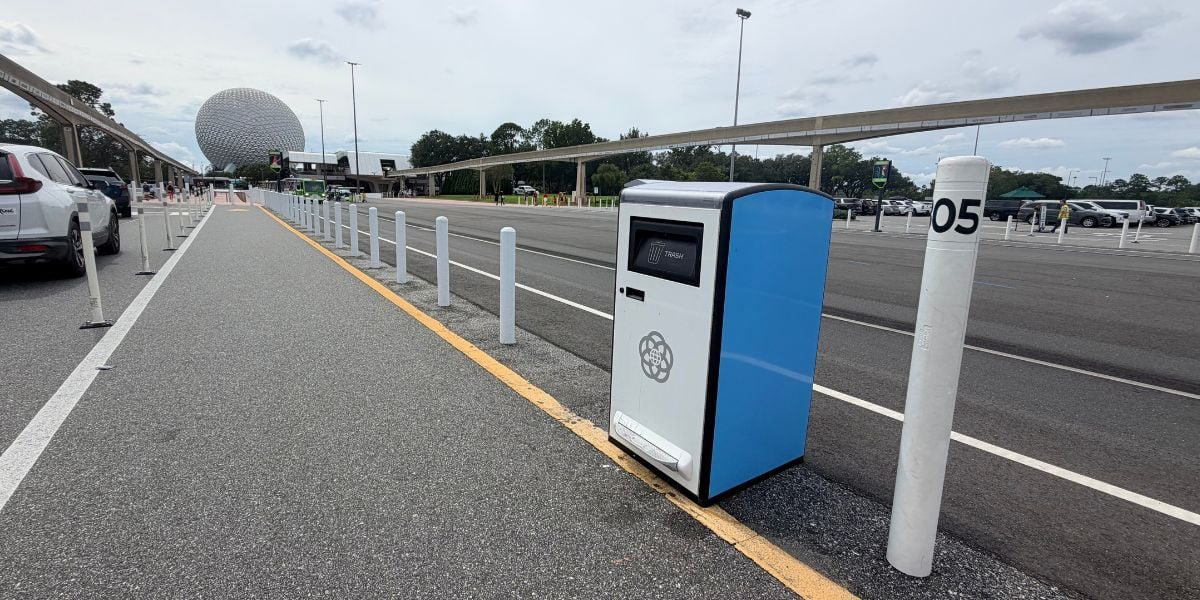 A trash can in a Disney World parking lot with Spaceship Earth in the distance.