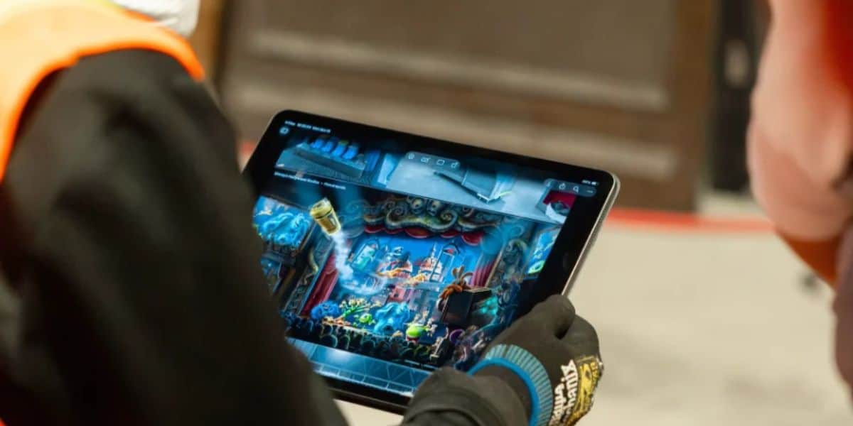 imagineer holding tablet with monstropolis concept art