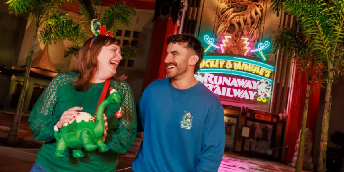 two guests at jollywood nights, one holding gertie loungefly bag and the other wearing gertie pullover shirt
