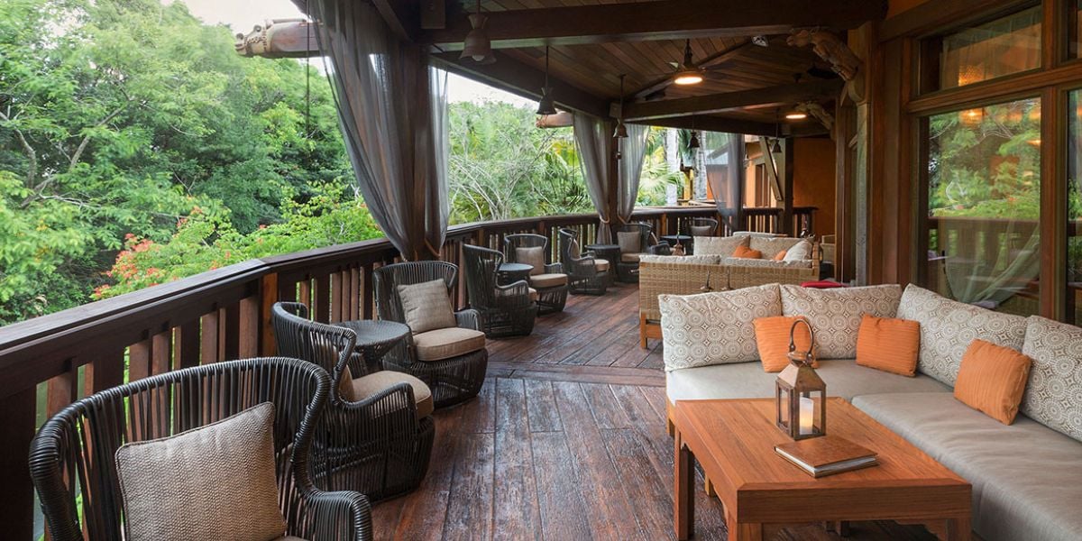 Covered outdoor seating on the porch at Nomad Lounge in Disney’s Animal Kingdom.