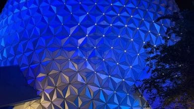close-up of glowing blue spaceship earth at night in epcot