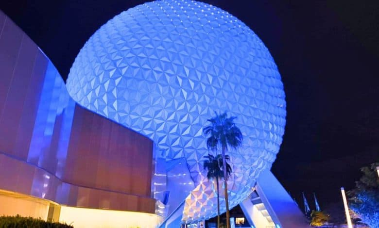 Spaceship Earth glowing blue at night at Disney World's EPCOT park