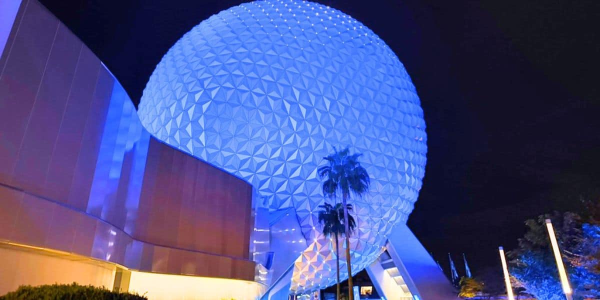Spaceship Earth glowing blue at night at Disney World's EPCOT park