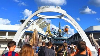 Guests walk through the Tomorrowland entrance at Magic Kingdom in Disney World