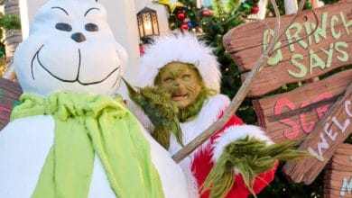The Grinch poses with a snowman at universal studios hollywood during holidays