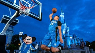 Aaron Gordon dunks a basketball alongside Mickey Mouse in front of Cinderella Castle at Walt Disney World.